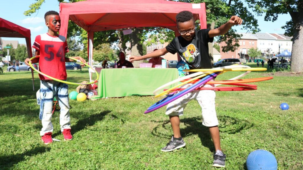 Kids using hula hoops at Ezz Fest in Laurel Park