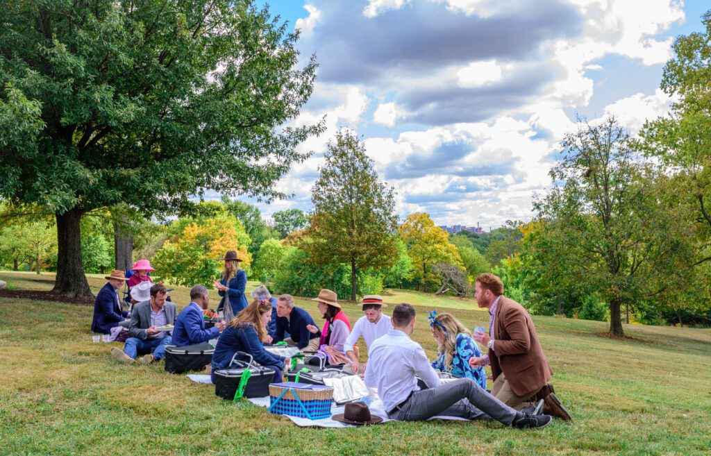 A group of people having a picnic for Hats Off Luncheon in Mt. Storm Park