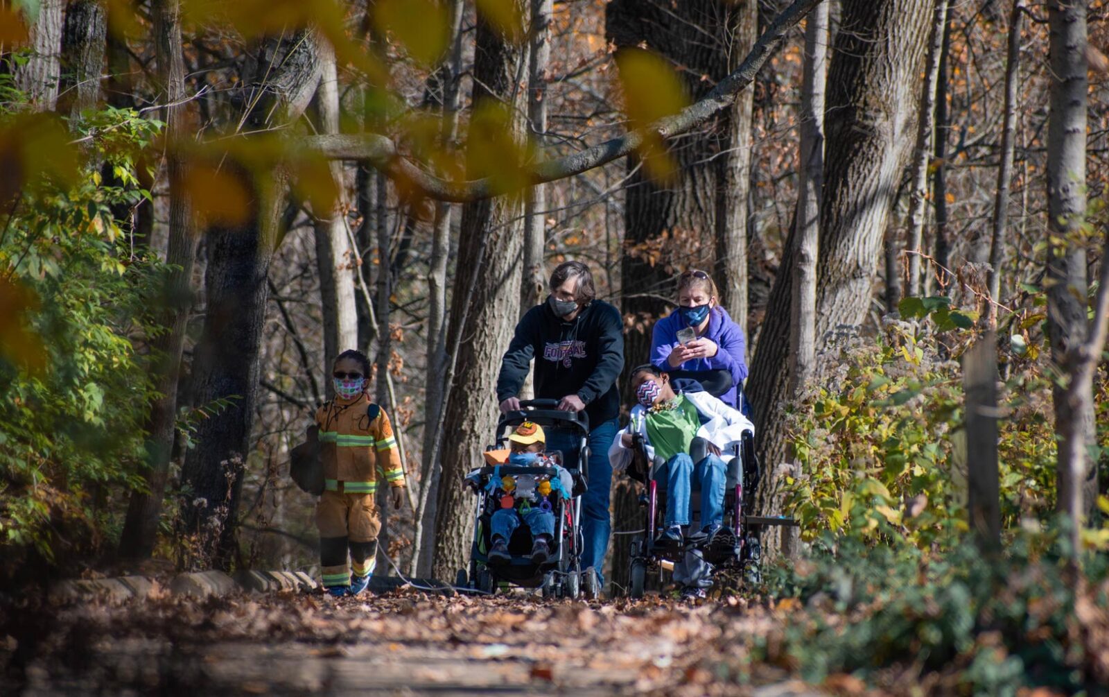 A family with children who use wheelchairs on the accessible trail in Cincinnati Parks Caldwell Nature Center