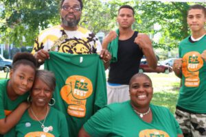 A group of volunteers wearing Ezz Fest t-shirts pose for a group photo