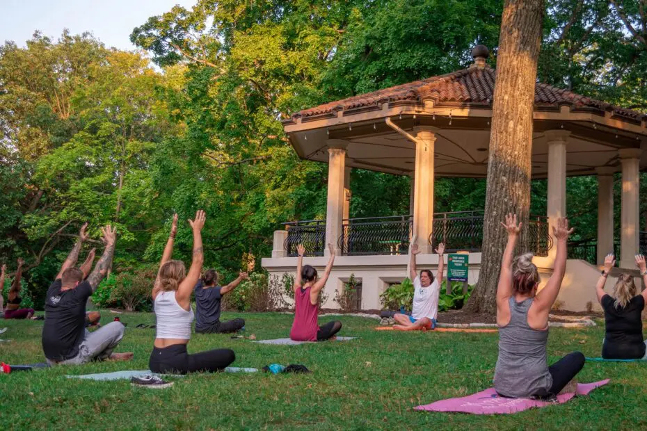 A group of people doing yoga at the Burnet Woods Bandstand