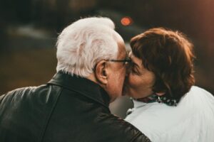 A senior couple sharing a kiss at sunset