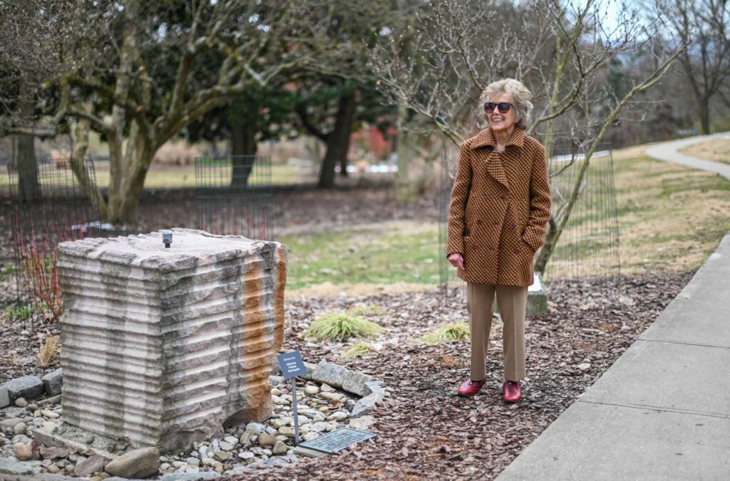 Marjorie stands by her sculpture in Eden Park