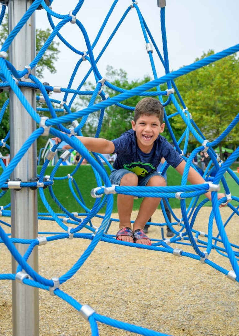 A young boy in a jungle gym