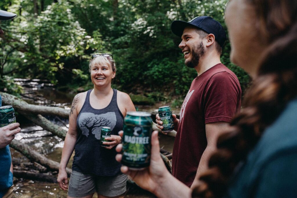 People hiking in the woods with MadTree Beer