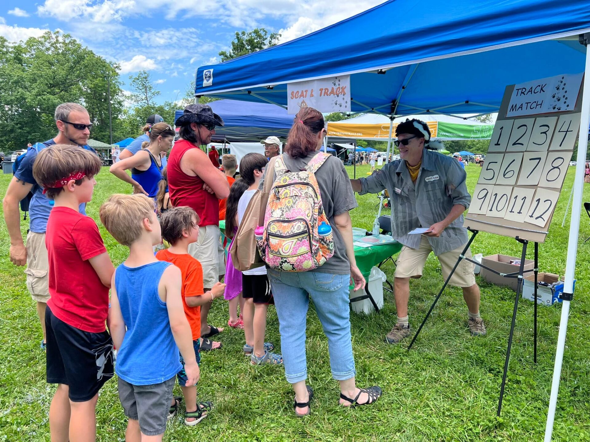 People at Trail Fest listening to a speaker and children's lesson