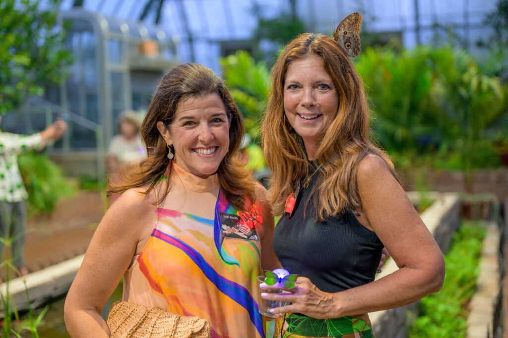 Members in The Women's Committee of Cincinnati Parks at a Krohn Conservatory butterfly event.