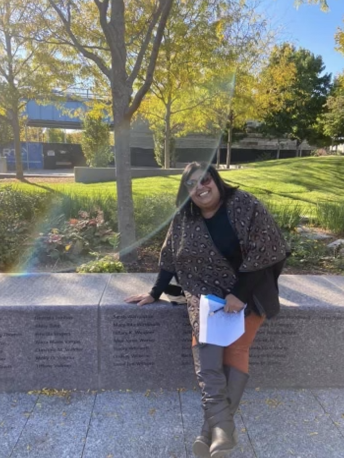 Lindsay Wilhelm sitting in the Women's Committee Garden at Smale Riverfront Park