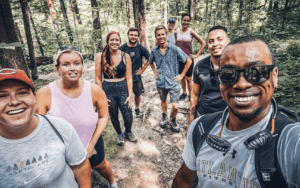 A group of people posing for a picture in the woods