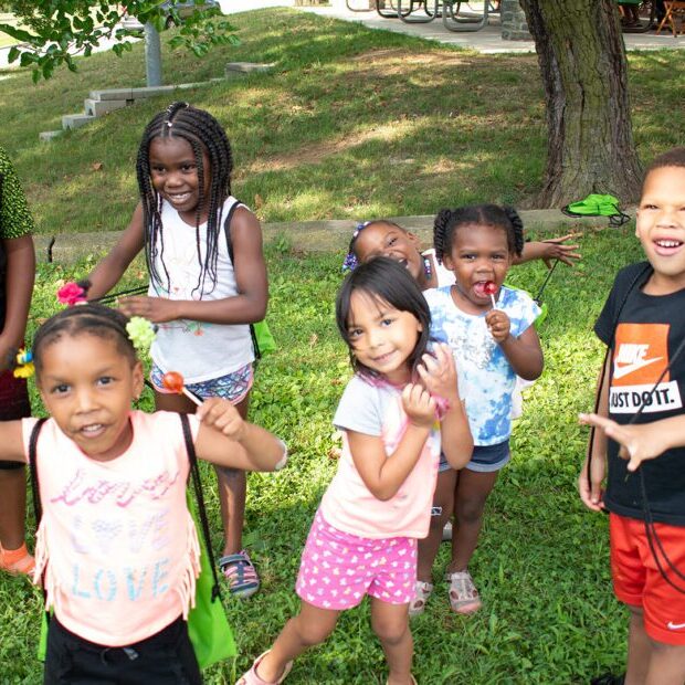 A group of children laughing and signing